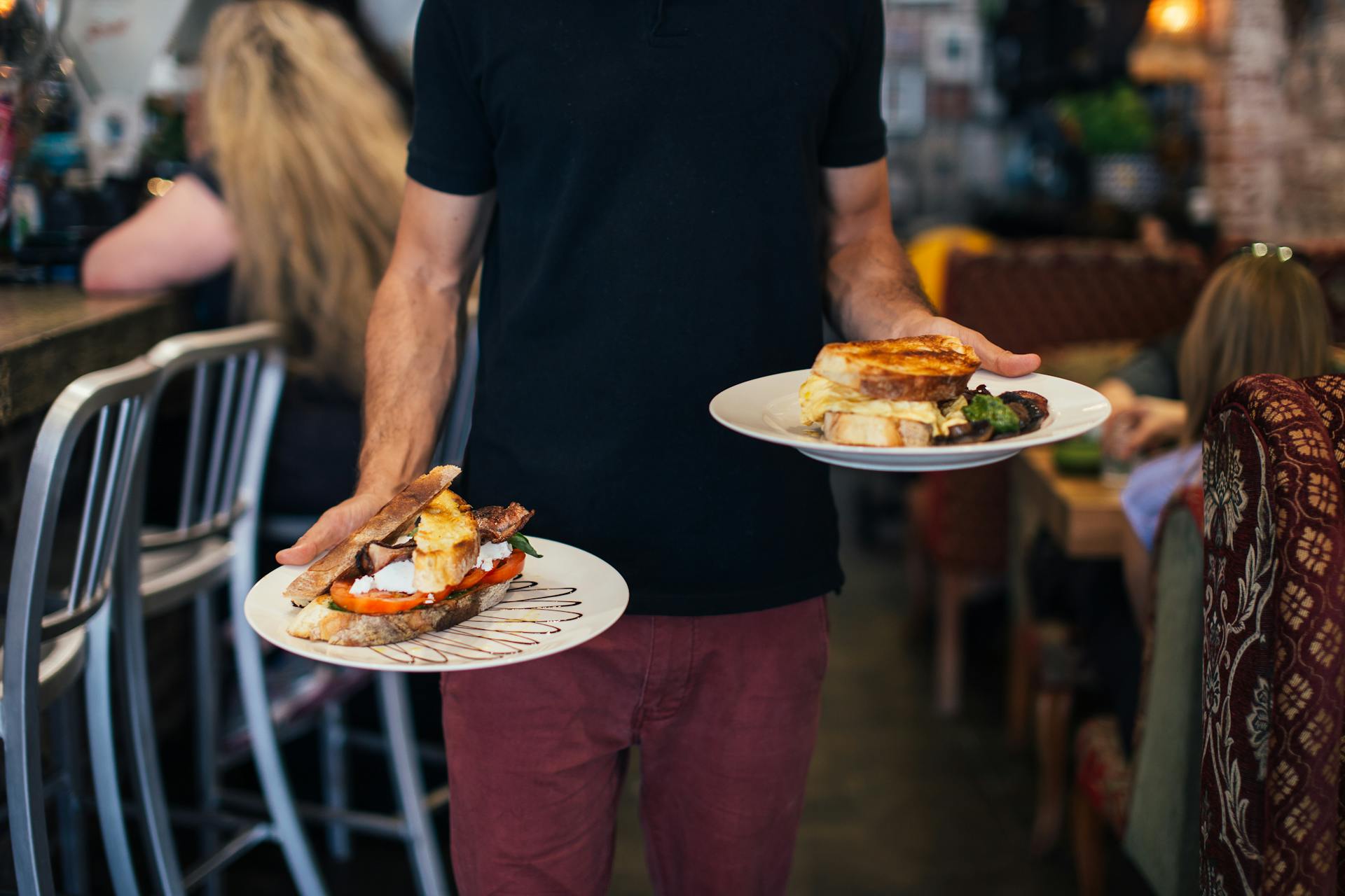 Person holding pastry dishes on white ceramic plates